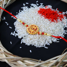 Golden Swastik Rakhi With Red Beads And Thread